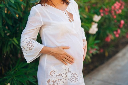 Pregnant woman holding belly with hands in Montenegroの写真素材