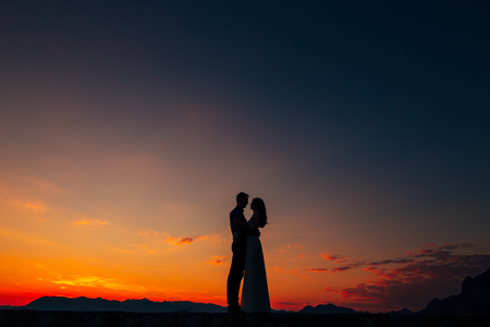 Silhouettes at sunset on Mount Lovcen in Montenegroの写真素材