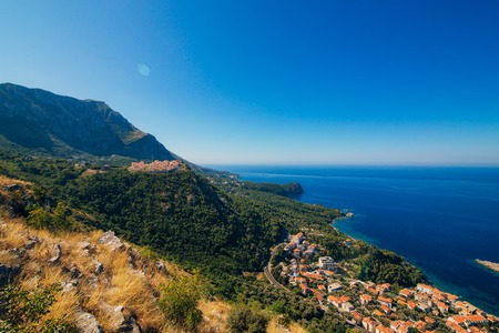 Russian village on the mountain in Montenegro over the island of Sveti Stefan.の写真素材