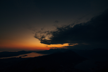 Sunset in Montenegro over the mountains and the sea. Orange sunsets.の写真素材