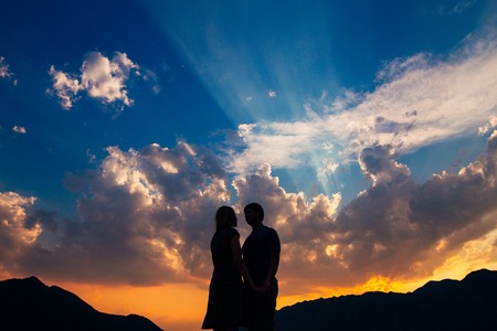 Silhouette of a newly-married couple on the background of the setting sun in Perast in Montenegro.の写真素材