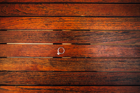 Gold wedding rings on a wooden backgroundの写真素材