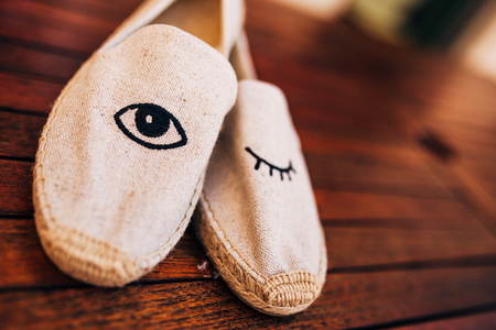 bouquet of flowers and greenery and shoes bride and groom lying on an old wooden benchの写真素材
