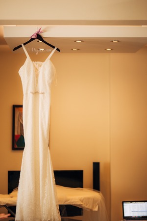 The brides dress on a hanger in the room in Montenegroの写真素材
