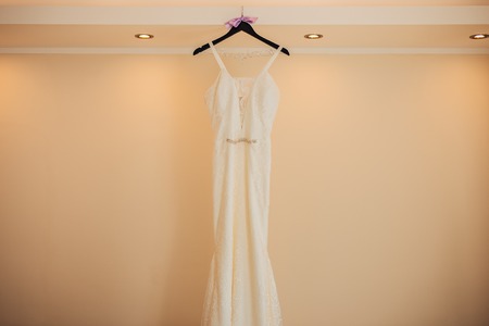The brides dress on a hanger in the room in Montenegroの写真素材