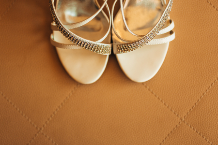 silver Bride shoes on a bed before ceremony. wedding conceptの写真素材