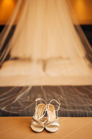 silver Bride shoes on a bed before ceremony. wedding conceptの写真素材