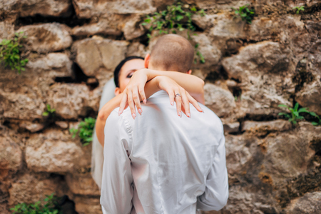 Bride and groom at wedding Day walking Outdoors on spring nature. Bridal couple, Happy Newlywed woman and man embracing in green park. Loving wedding couple outdoor. Bride and groomの写真素材