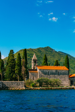 The island of Gospa od Skrpela in the Boko-Kotorsky Gulf near the town of Perast in Montenegro.の写真素材