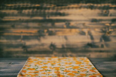 Fabric towel with a floral pattern on a wooden backgroundの写真素材