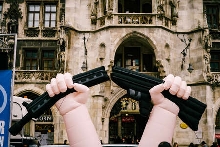 Munich, GERMANY - 9 MARCH 2018: No war rally. An inflatable balloon of a broken machine gun, on a demonstration against the war. Symbol of a broken weapon.のeditorial素材