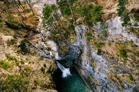 Waterfall near Neuschwanstein Castle. A small waterfall in the mountains among the rocksの写真素材