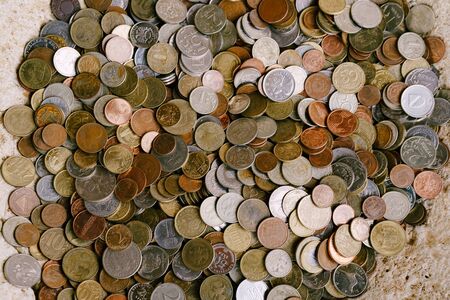 Coin texture. Coins from different countries. Pig pile of pennies. の写真素材
