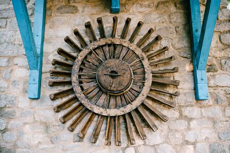The wheel of a water mill. The old wooden wheel of the water mill is used as an element of decor on the wall.の写真素材