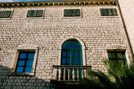 Beautiful vintage balconies in Venetian style in the Black Mountains of stone and metal with columns against the background of historic buildingsの写真素材