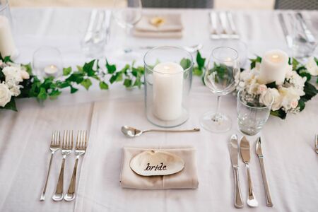 The inscription BRIDE on the shell in the center of the table. Serving a table - knives, forks,...