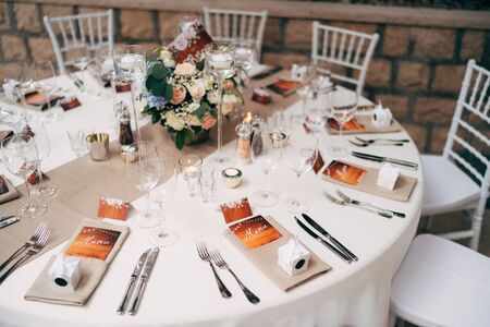 Wedding dinner table reception. Round table with white tablecloth with brown runner on table. Vienna...