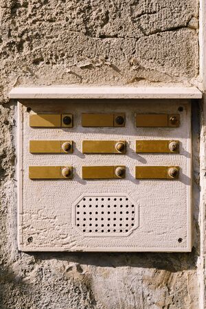 Close-ups of building facades in Venice, Italy. An old vintage intercom and a mailbox on a stone...