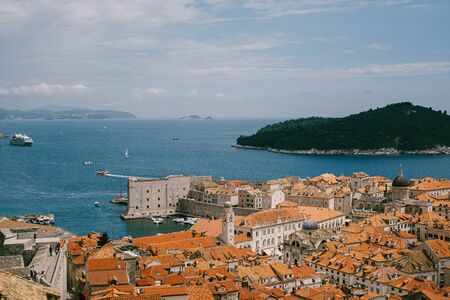 View from the wall on the roofs of the old city of Dubrovnik, the bell tower of the Dominican monastery, the dome of the church of St. Vlah and the Cathedral of the Assumption of the Virgin Maryの写真素材