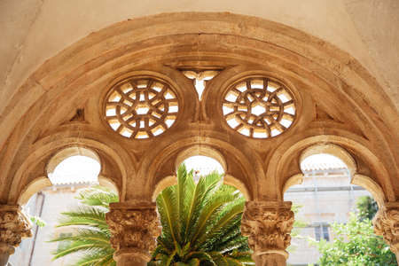 Dubrovnik, Croatia - 04 may 2016: Columns and arches of a courtyard with a garden of the Dominican monastery in Dubrovnik, Croatia.のeditorial素材