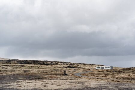 Yellow dry grass to the horizon, a road going into the distance, a lonely house standing on a hill...