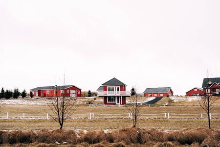 A street in Iceland with red houses, hotels and cottages.の写真素材