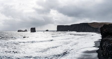 Black sand beach and the basalt mount Reynisfjall, Vik, Iceland.の写真素材
