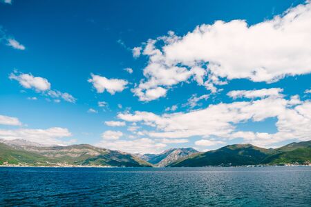 Blue sky with snow-white clouds over the Gulf of Kotor in Montenegro.の写真素材