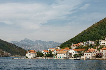 The coastline of the city of Lepetane in Montenegro, near the ferry crossing through Kotor Bay.