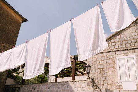 White towels are dried between houses in Perast, Montenegro.の写真素材