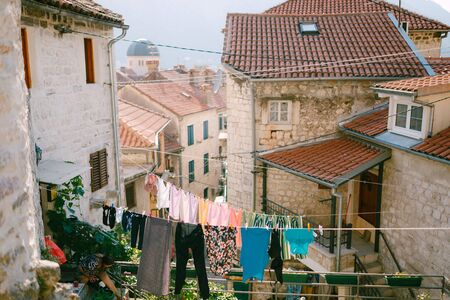 Clothes are dried on a rope, between buildings in the old town of Kotor, Montenegro.の写真素材