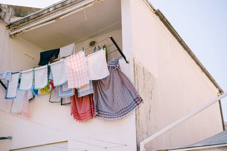 Kitchen towels are dried on the balcony.
