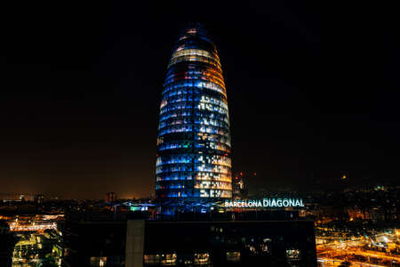 Barcelona, Spain - 15 December 2019: Agbar Tower - modern 34-storey skyscraper at 211 Diagonal Avenue, Barcelona, Catalonia on the border of new technological quarter, night illumination is turned onのeditorial素材