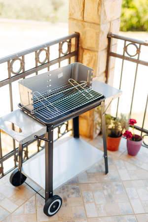 Metal portable mobile grill on the balcony.の写真素材