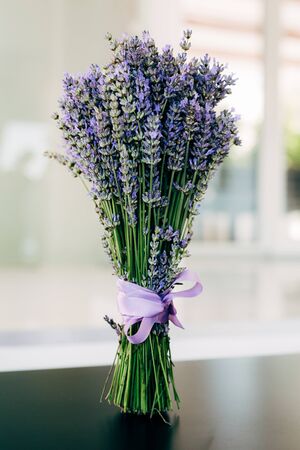 a bouquet of lavender with ribbons on the table. High quality photoの写真素材