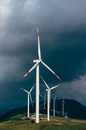 High wind turbines against the lead sky.の写真素材