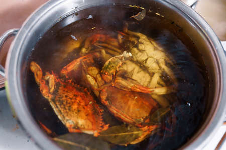 Red boiled blue crabs in boiling water with seasonings. High quality photoの写真素材