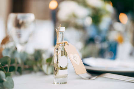 A little gift bottle of alcohol on the wedding table.の写真素材