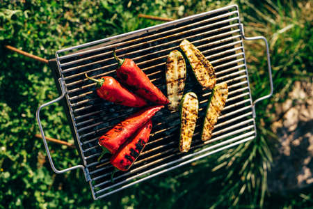 Grilled vegetables on the grill outside. Sliced zucchini and paprika.の写真素材