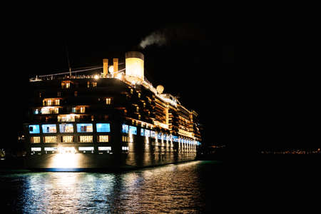 Close-up of a cruise liner in the sea at night. Night lighting of the ship.の写真素材