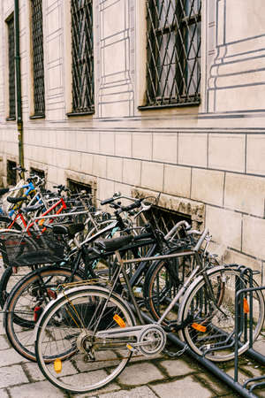 Bicycle parking by a beige building with barred windowsの写真素材