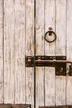 Wooden door with metal bolt and ring handle
