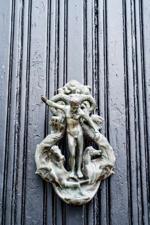 Antique ring door handle with antique male figure and horses.の写真素材