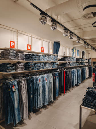 Budva, Montenegro - 01 august 2020: Jeans in the store. The goods are on the shelves. Stylish fashion boutique.のeditorial素材