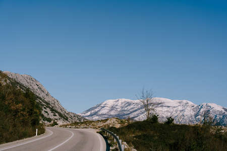 Mountain serpentine road with mountain views under a blue cloudless sky.の写真素材