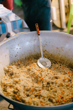 A huge cauldron with Uzbek pilaf.の写真素材