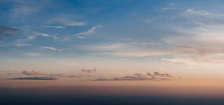 Pink and blue sunset sky with colorful clouds.の写真素材