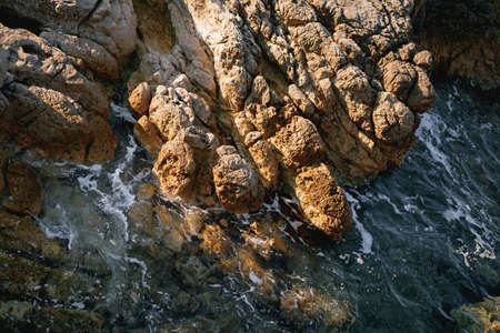 Rocks in the sea, waves hitting rocks.