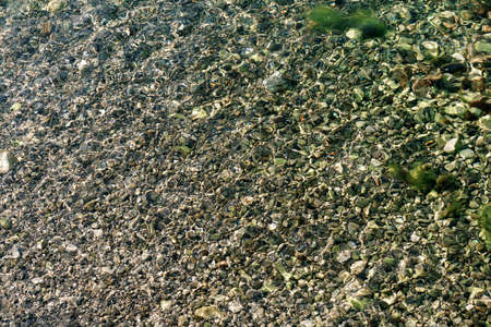 Pebble texture under sea water.
