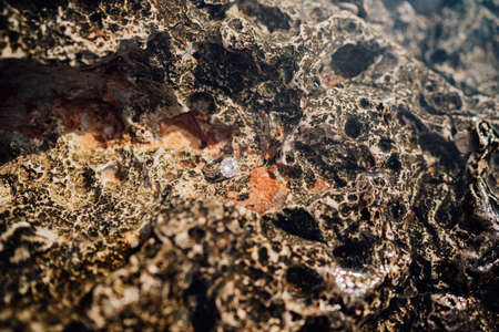 Close-up of a gemstone engagement ring underwater.
